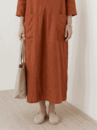 100% cotton pocket maxi dress with 3/4 sleeves and side slits in a relaxed A-line silhouette