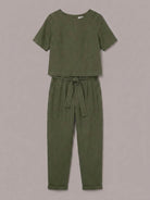 Model wearing a relaxed fit 100% cotton linen set with short-sleeve top and straight-leg pants in monochrome tones