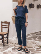 Woman wearing relaxed cotton linen set with short-sleeve top and straight-leg pants in monochrome tones
