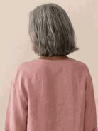 white pure linen age-defying shirt with button detail on hanger against white background
