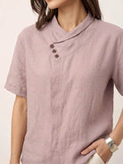 woman wearing 100% linen relaxed V-neck top with asymmetric buttons and short sleeves