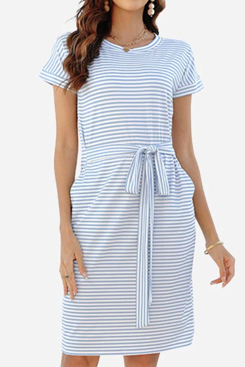 Woman wearing Airy Stripe Sheath Cotton Dress with blue and white stripes, short sleeves, crew neck, side pockets, and a tie waist belt