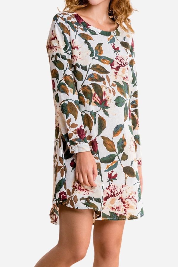 Woman wearing all over floral print linen shift dress with long sleeves and relaxed fit