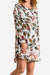 Woman wearing all over floral print linen shift dress with long sleeves and relaxed fit