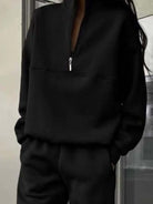 Woman wearing a stylish cotton-blended two-piece tracksuit with high collar and zipper outdoors