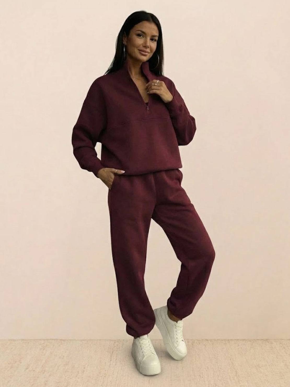 woman wearing cotton-blended two-piece tracksuit with high collar and deep zipper in casual athleisure style