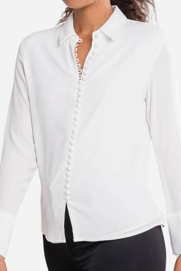 White Bayam Blouse with button detail and long sleeves, 100% polyester, classic fit.