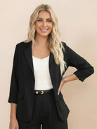 Woman wearing a polished blazer and high-waisted shorts two-piece set in a neutral color