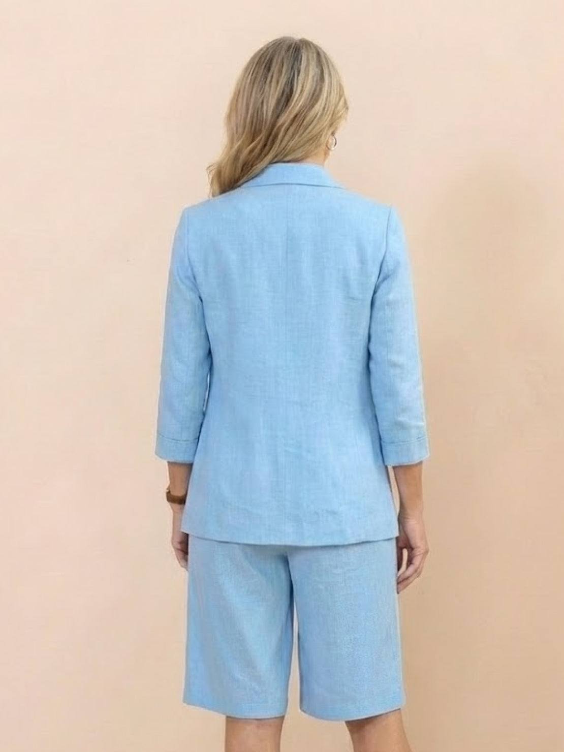 Woman wearing a polished blazer and high-waisted shorts two-piece set in a sleek, monochrome design