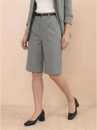 Woman wearing a polished blazer and high-waisted shorts two-piece set in a monochrome outfit