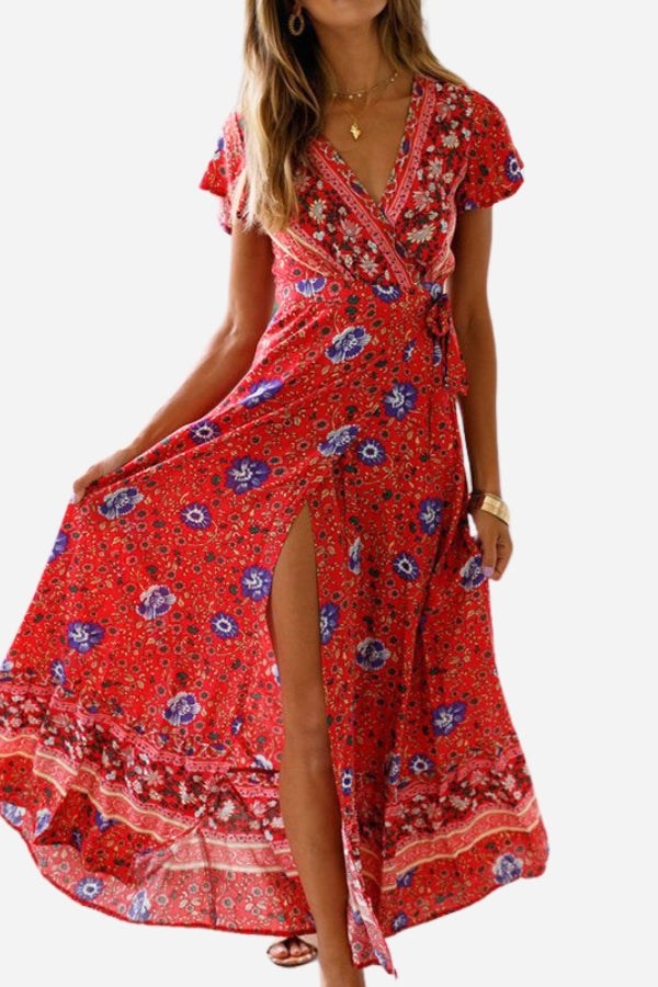 Bohemian floral print wrap dress in red with V-neck and high side slit, short sleeves, and ruffle skirt design.