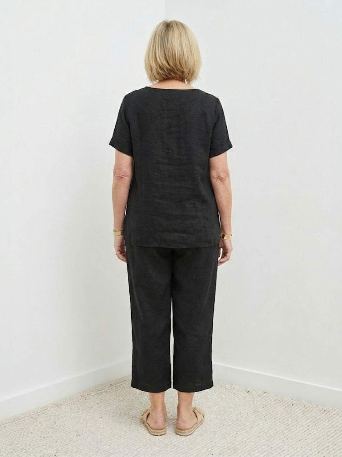 Woman wearing breezy cotton blend two-piece set with short sleeves and elastic waist pants