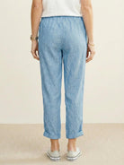 Woman wearing breezy relaxed fit straight pants, showcasing supreme comfort and stylish casual look