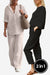Two women wearing breathable casual chic duo sets, one in white relaxed cotton shirt and trousers, the other in black comfortable loose-fit top and pants, styled for versatile mix and match looks.