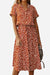 Woman wearing a casual bohemian dress skirt with boho dot print and lace-up waist in rust color