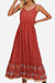 Woman wearing a casual vintage flower prints red maxi dress with spaghetti straps and elastic waist