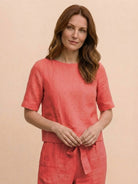 Woman wearing relaxed monochrome cotton linen set with short sleeve top and straight-leg pants