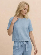 Woman wearing relaxed cotton linen set with short-sleeve top and straight-leg pants in monochrome tones
