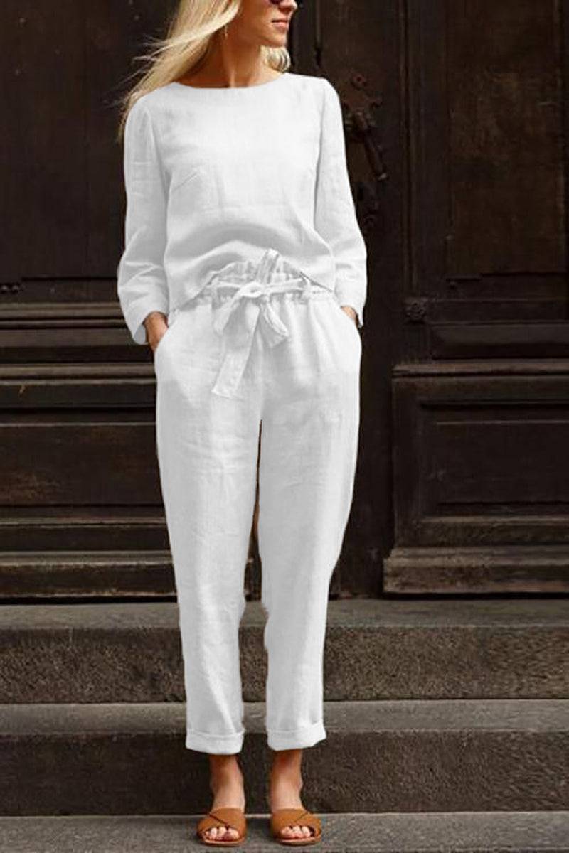 Woman wearing white relaxed longline top and wide-leg pants cotton-linen monochrome capsule outfit