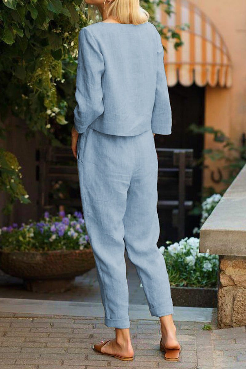 Back view of woman wearing a relaxed cotton-linen monochrome capsule set with longline top and wide-leg pants in light blue.