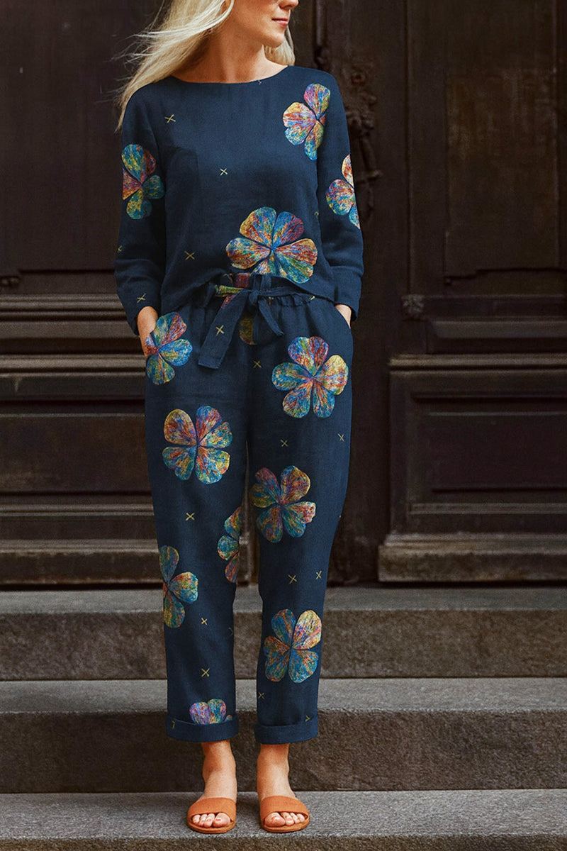 woman wearing navy cotton-linen floral print relaxed longline top and wide-leg pants set with colorful flowers