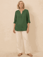 white pure linen age-defying shirt with button detail on wooden hanger