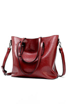 Red multi strap tote shopper bag made of PU leather with multiple compartments and adjustable straps.