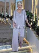 Woman wearing Elegant Layers Two-Piece Set with layered V-neck top and matching pants