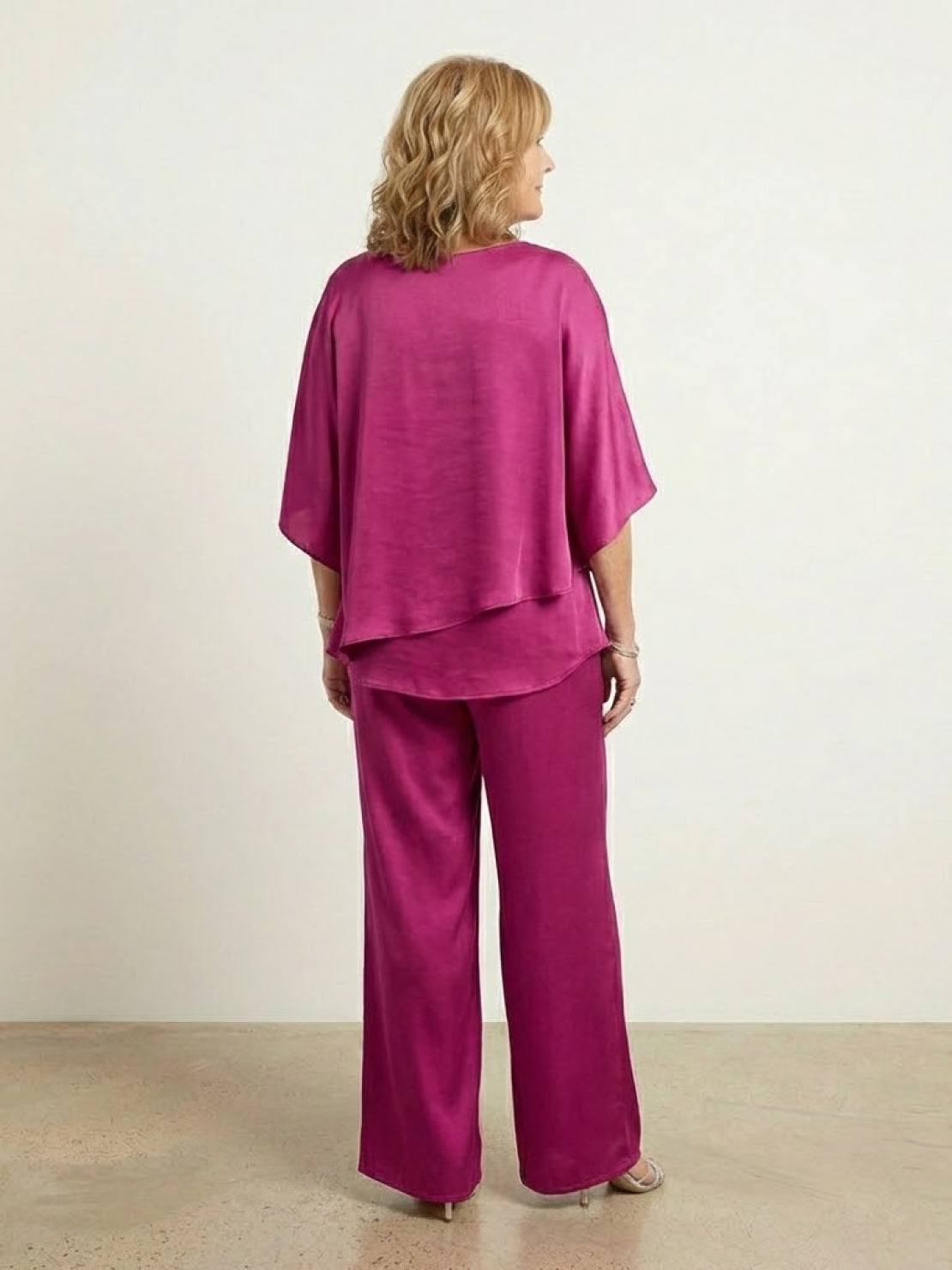 Woman wearing Elegant Layers Two-Piece Set with layered V-neck top and matching pants in soft fabric.