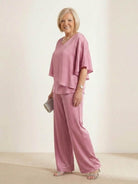 woman wearing Elegant Layers Two-Piece Set with layered V-neck top and matching pants in soft fabric