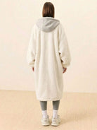 Back view of a person wearing an everyday wear oversized sherpa long coat with a hood, showcasing the cozy and plush texture.