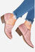 Pink laser cut western ankle boots with zipper and low wooden heel worn with frayed hem blue jeans