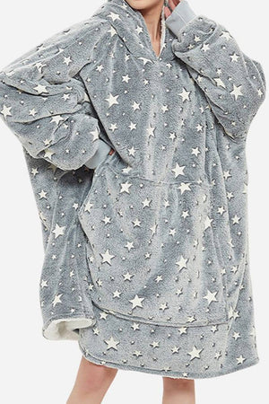 Oversized gray Lazy Fleece Blanket Sweater with white star pattern, hood, and front pocket, made of soft fleece and sherpa fabric for warmth and comfort.