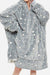 Oversized gray Lazy Fleece Blanket Sweater with white star pattern, hood, and front pocket, made of soft fleece and sherpa fabric for warmth and comfort.