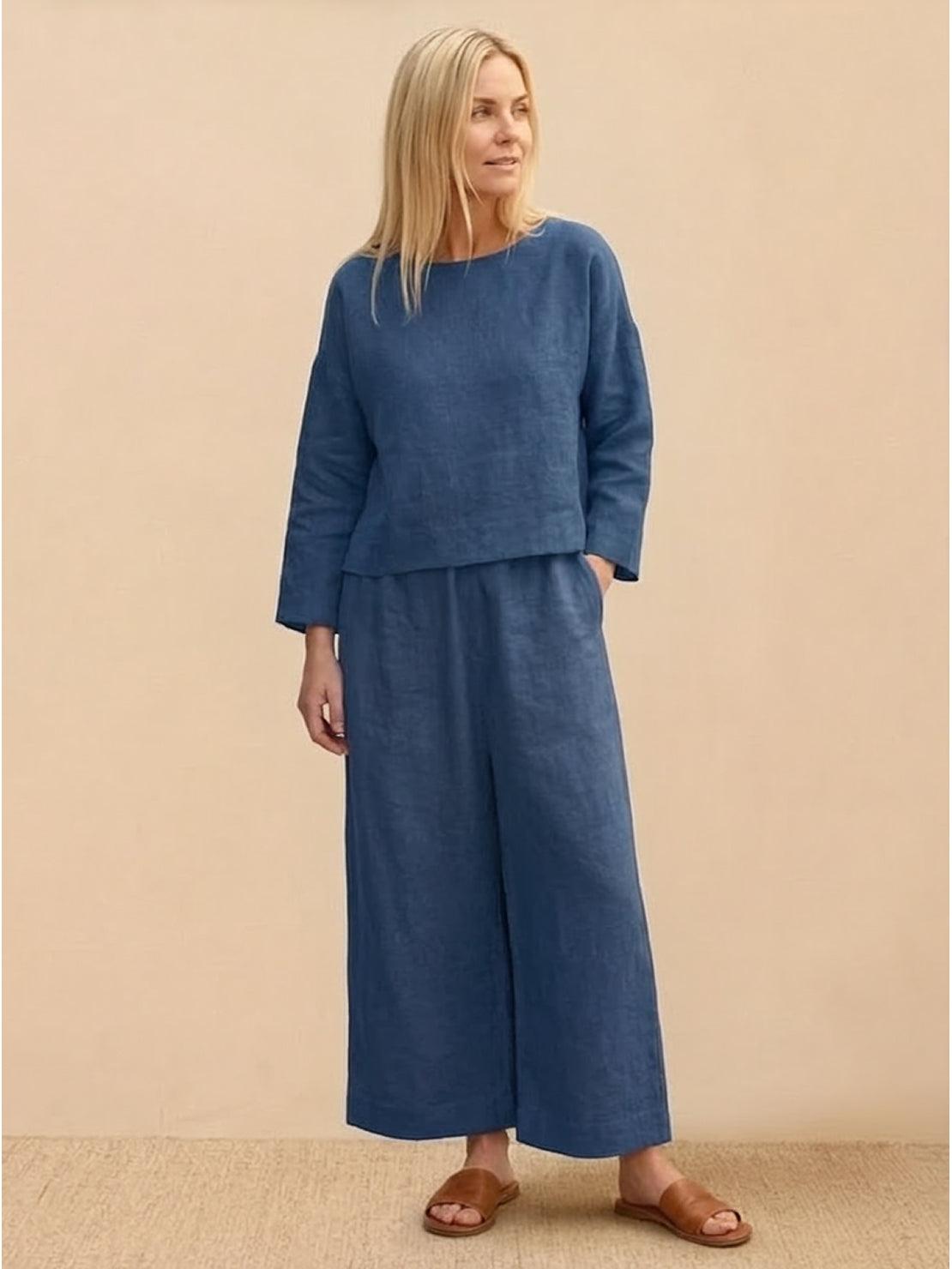 Woman wearing loose solid color blue two-piece linen set with long sleeves and wide-leg pants