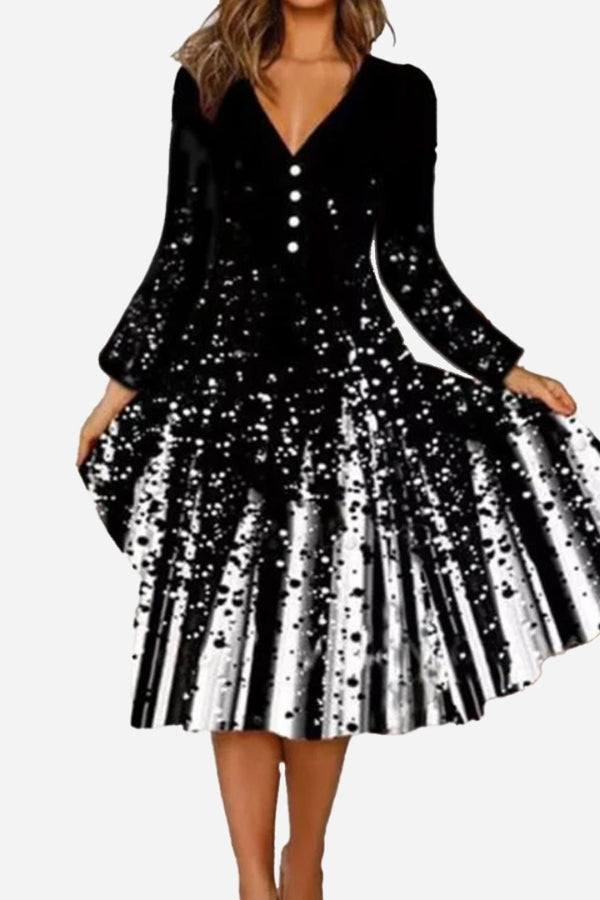 Loose waist long sleeve black and white V-neck dress with button details and flared skirt