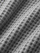 Woman wearing a pink two-piece oversized set for multi-weather comfort with relaxed fit and mid-weight fabric