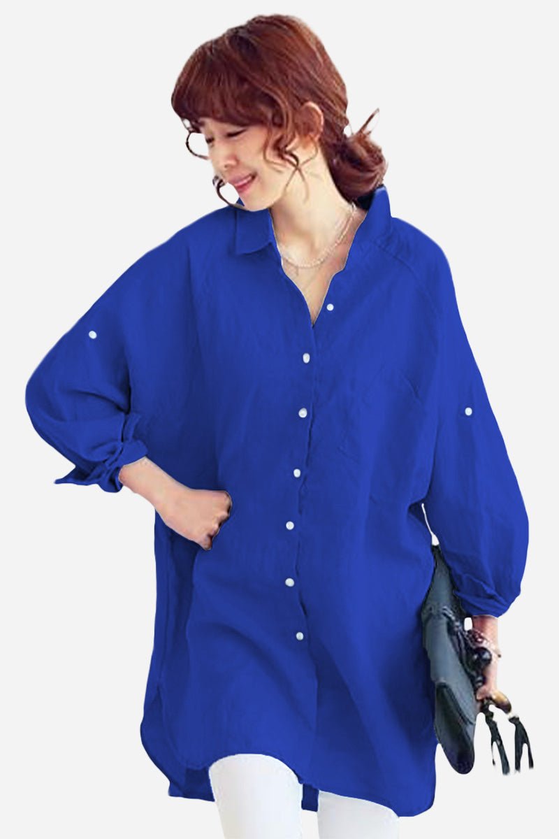 Woman wearing oversized linen shirt in blue, relaxed fit with button details and loose sleeves