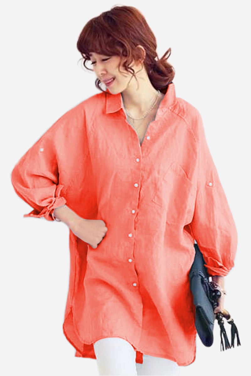 Woman wearing oversized linen shirt in sun-washed pink with loose sleeves and button details