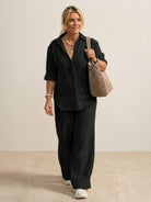 Woman wearing oversized 100 cotton black shirt and wide-leg pants co-ord set with relaxed fit and natural texture