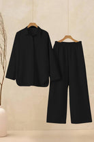 Oversized 100 cotton shirt and wide-leg pants co-ord set in black hanging on wooden hangers