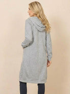Woman wearing oversized long zip sweatshirt hoodie in gray viewed from back