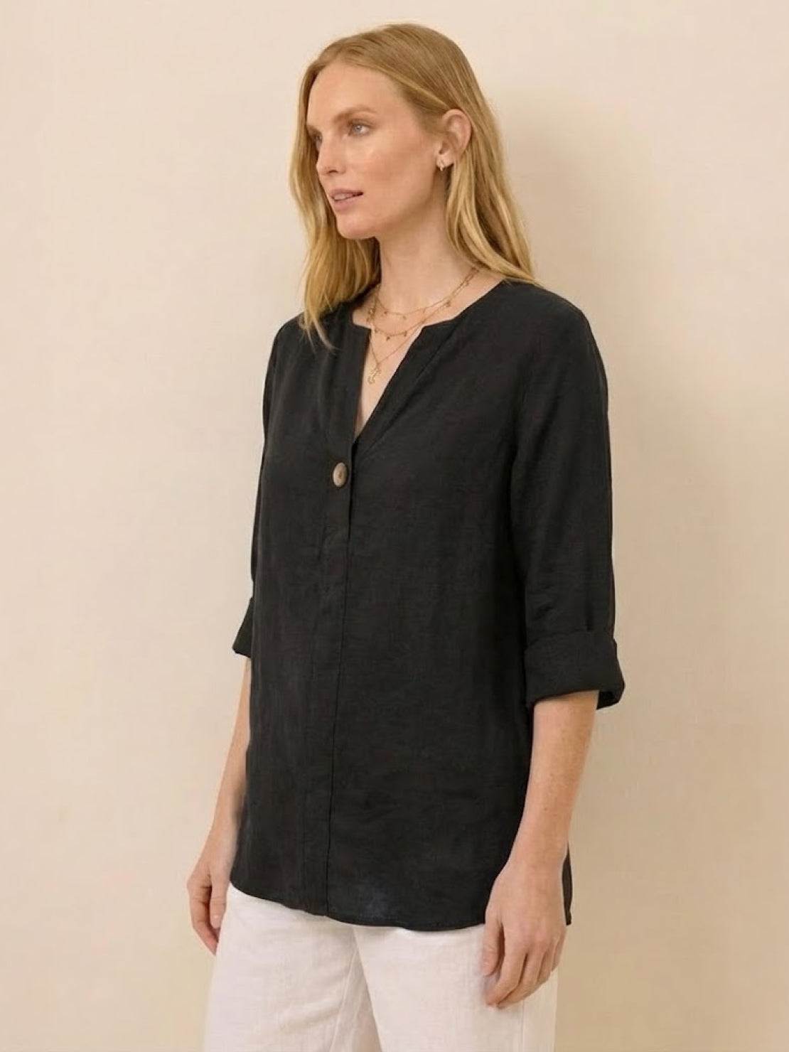woman wearing black pure linen age-defying button detail shirt with rolled sleeves
