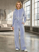 woman wearing modern cropped velour tracksuit set with high-waist pants in vibrant color