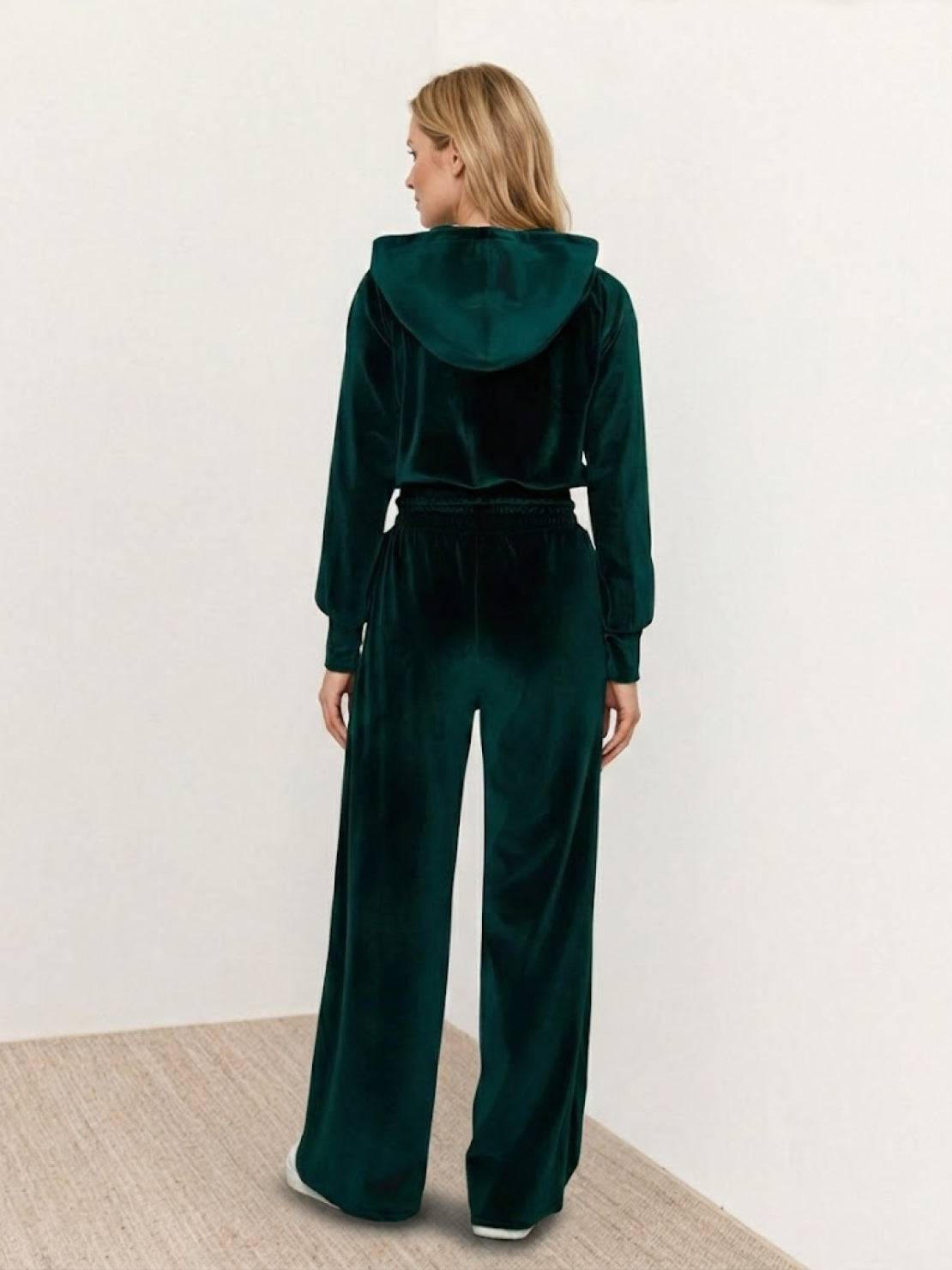 Modern velour tracksuit set with cropped hoodie and high-waist pants in plush polyester fabric