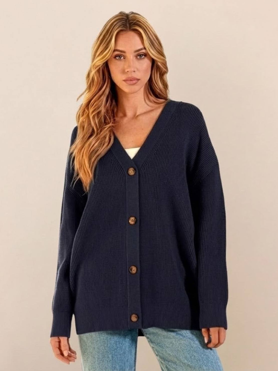 Relaxed fit oversized button-down knitwear cardigan in navy blue worn by woman