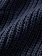 Close-up of navy blue relaxed fit oversized knitwear cardigan fabric texture