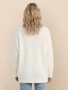 Relaxed fit oversized white knit cardigan worn by woman shown from the back