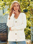 woman wearing relaxed fit oversized white button-down knitwear cardigan outdoors