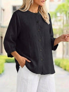Relaxed loose breathable linen black blouse with button-down front and three-quarter sleeves for casual summer wear